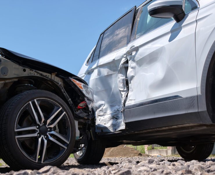 Cars crashed heavily in road accident after collision on city street. Road safety and insurance concept